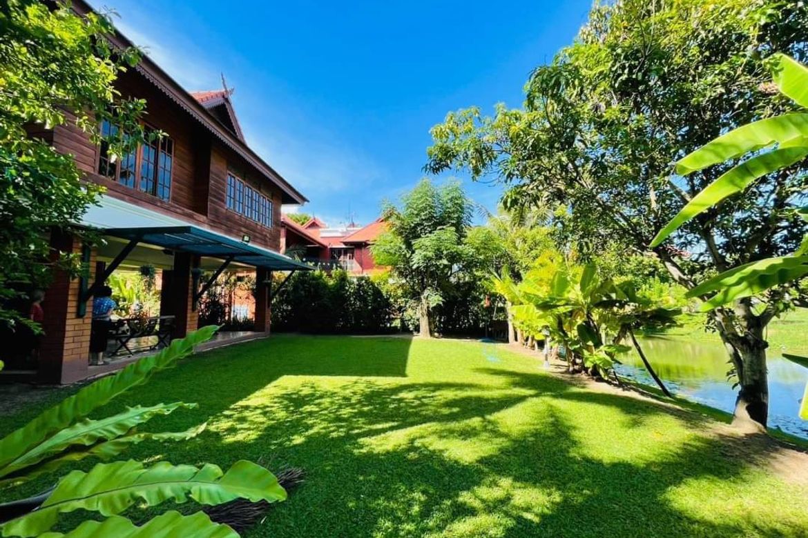 Applied Thai style house for sale. Built with golden teak behind the house next to the lake In a quality project